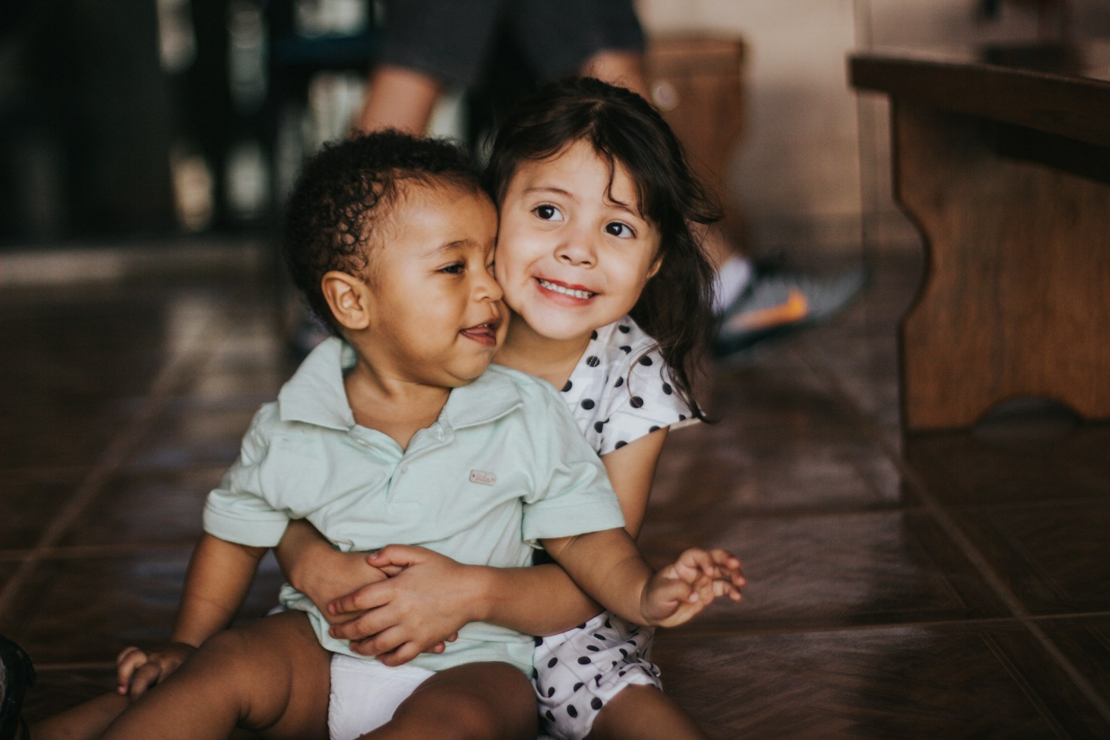 Photo by Chayene Rafaela selective focus photography of girl hugging boy